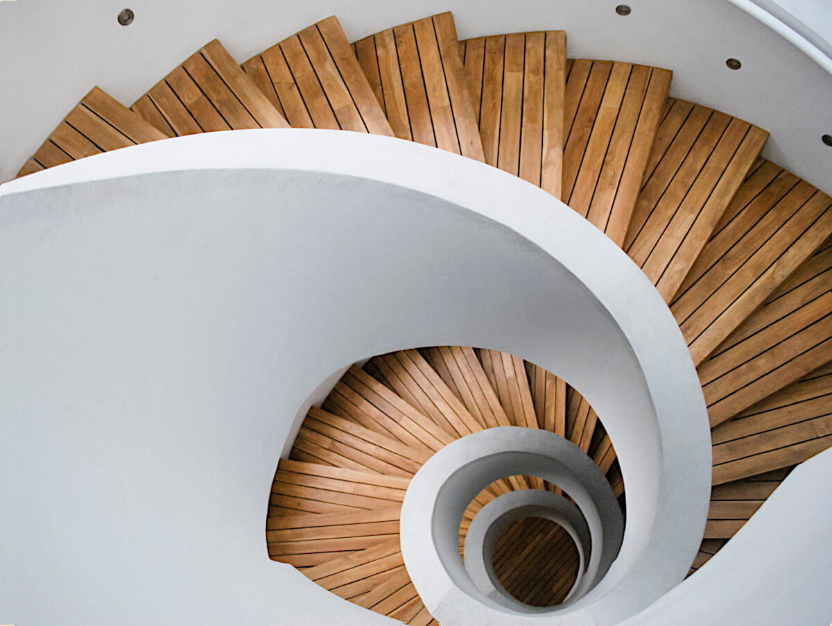 Composite Wood Flooring and White Wall Paint Products on Spiral Stairway