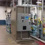 Pollution Systems OEM Electric Recuperative Catalytic Oxidizer (ERCO), skid-mounted and prepared for installation at a metal packaging facility.
