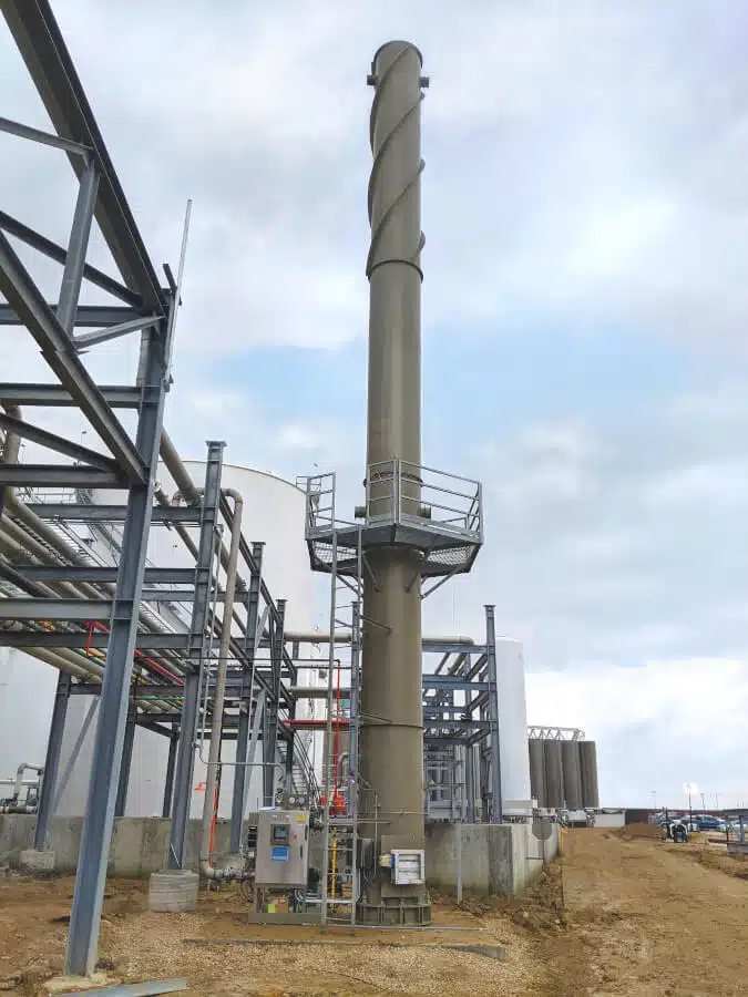 Pollution Systems OEM Vertical Enclosed Flare (CEF) with integrated emission testing platform for VOC abatement at an industrial chemical processing plant in the US.
